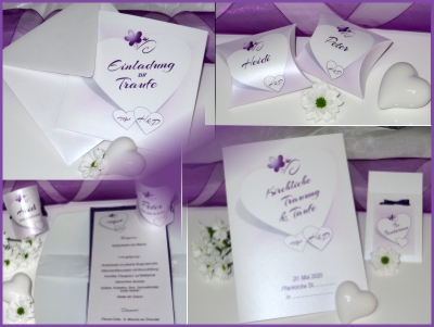 Fliederfarbenen Hochzeitskarten und passende Dekoration.